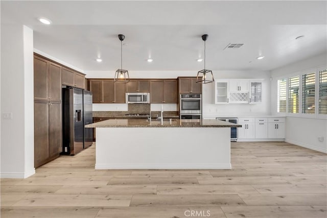 kitchen with visible vents, appliances with stainless steel finishes, wine cooler, and light wood-style flooring