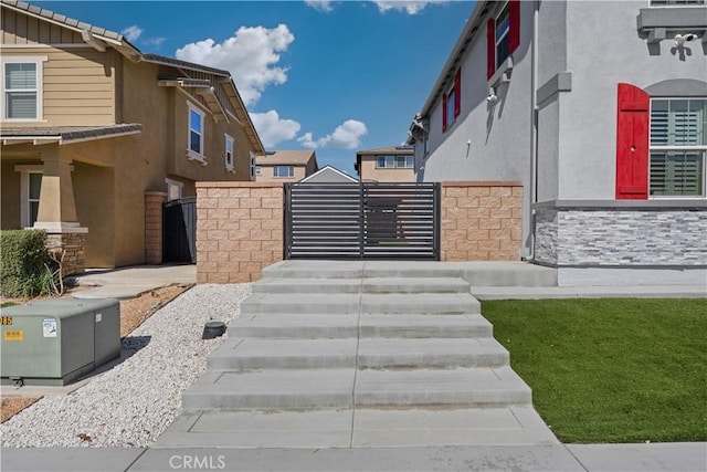 view of property's community with a gate and fence