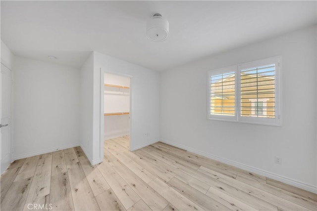 unfurnished room featuring wood finished floors and baseboards