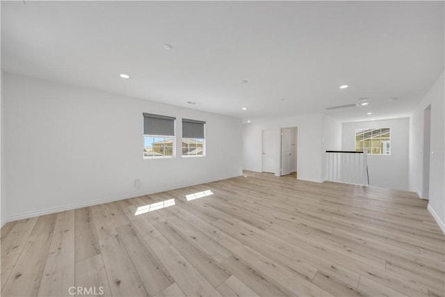 unfurnished room with baseboards, light wood-type flooring, and recessed lighting