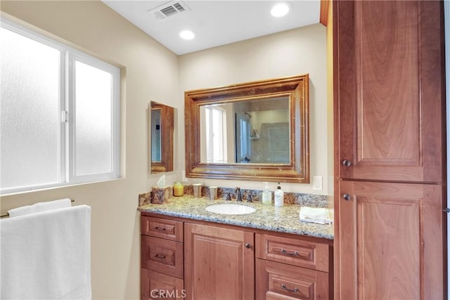 bathroom featuring recessed lighting, visible vents, and vanity