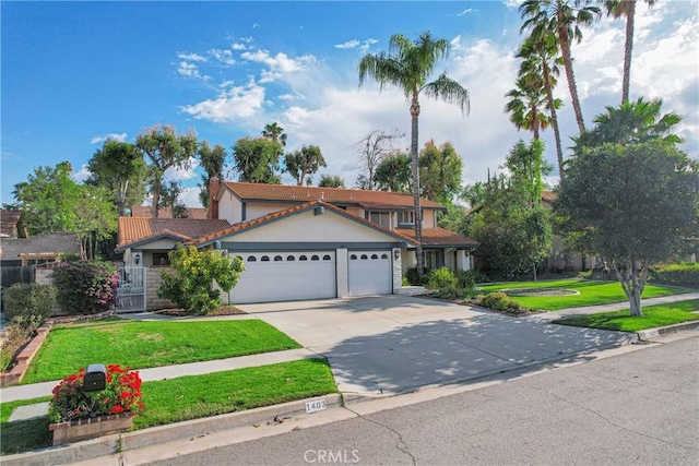 view of front of house featuring a garage, a tiled roof, concrete driveway, and a front yard