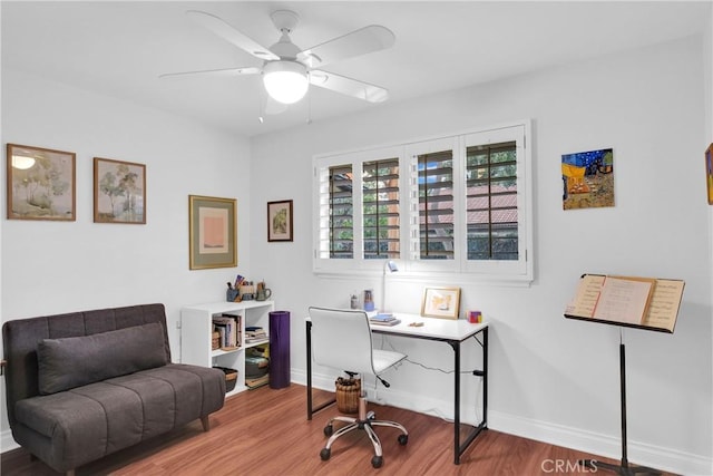 office with wood finished floors, a ceiling fan, and baseboards