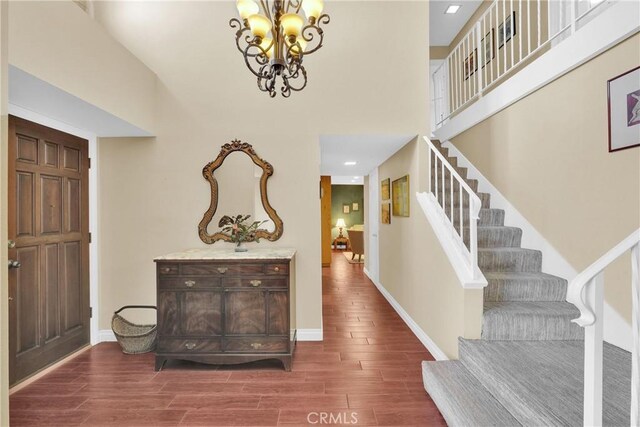 entryway featuring stairway, baseboards, and wood finished floors