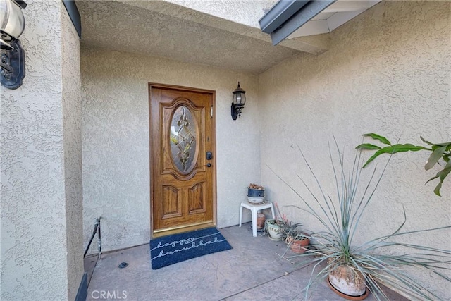 entrance to property with stucco siding