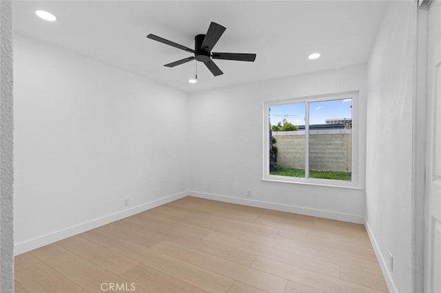 spare room with light wood finished floors, recessed lighting, baseboards, and ceiling fan