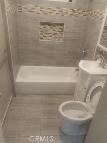 full bathroom featuring toilet, bathing tub / shower combination, and vanity