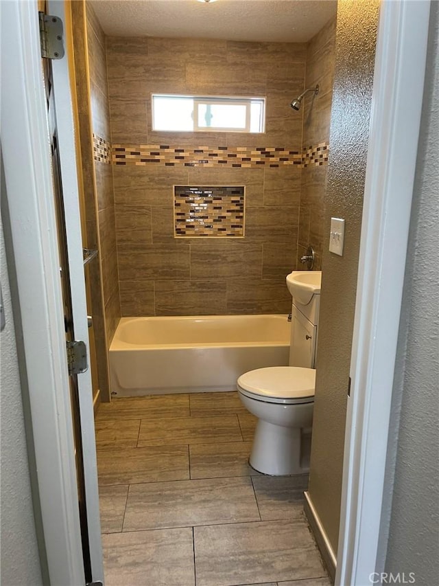 bathroom featuring shower / bathtub combination, wood finish floors, vanity, and toilet