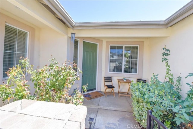 entrance to property featuring stucco siding