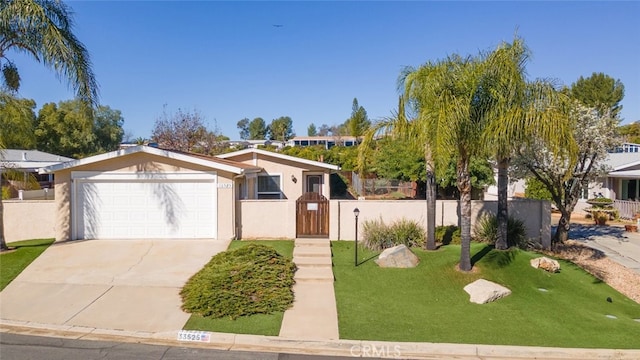 view of front of home with a fenced front yard, stucco siding, a gate, a garage, and driveway