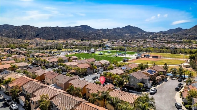 birds eye view of property with a mountain view and a residential view