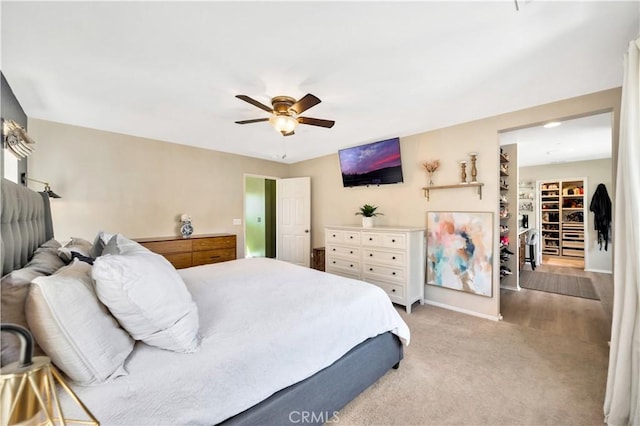 carpeted bedroom featuring a ceiling fan and baseboards