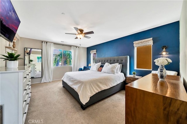 bedroom featuring ceiling fan, baseboards, and light carpet