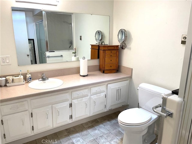 full bathroom with a shower stall, toilet, and vanity