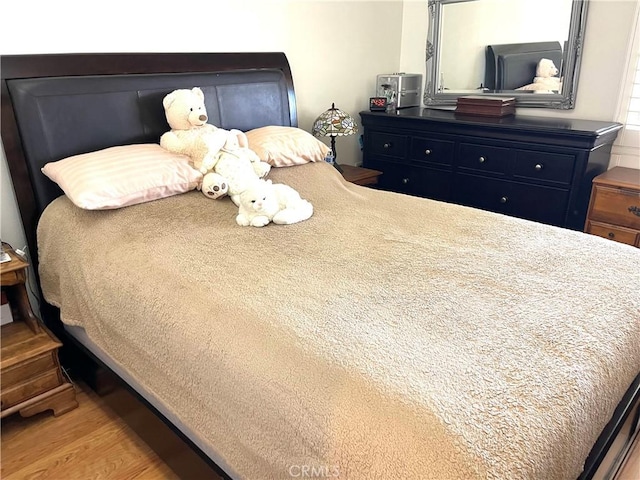 bedroom with wood finished floors