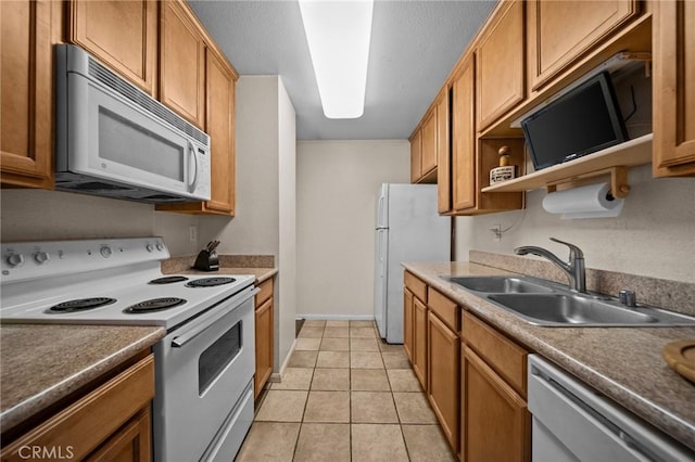 kitchen featuring white appliances, brown cabinetry, open shelves, a sink, and light tile patterned flooring