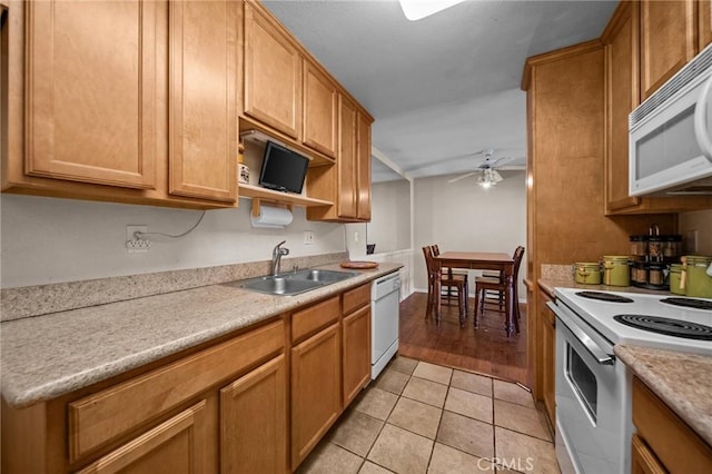 kitchen with white appliances, a ceiling fan, light countertops, and a sink