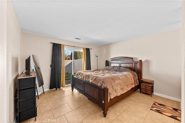 bedroom with light tile patterned floors, access to outside, and baseboards