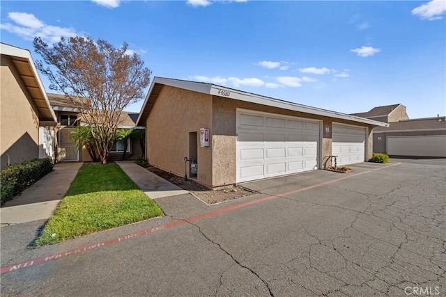 44680 La Paz Rd, Temecula, CA 92592 - view of home's exterior featuring community garages and stucco siding