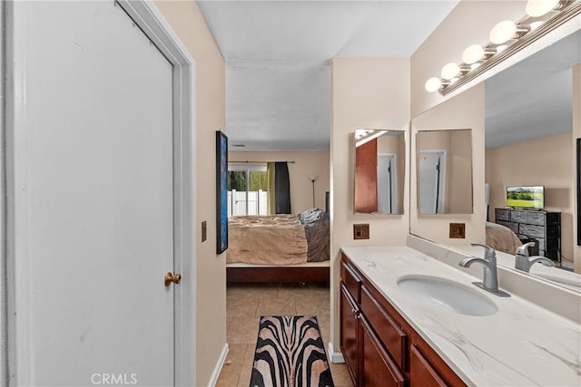 ensuite bathroom featuring tile patterned flooring, ensuite bath, and vanity