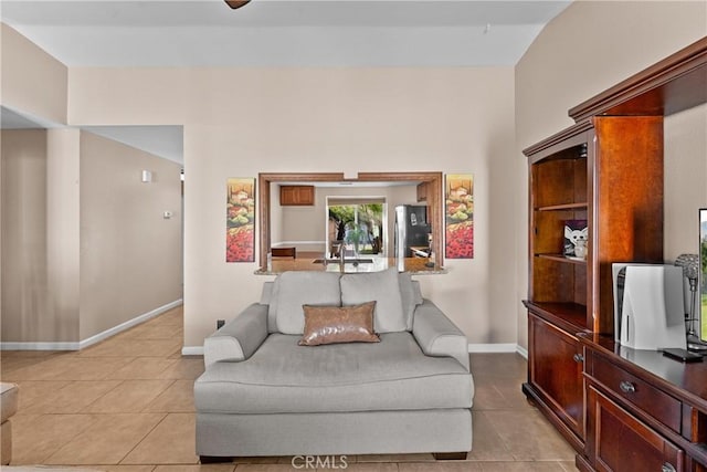 living room with light tile patterned floors and baseboards