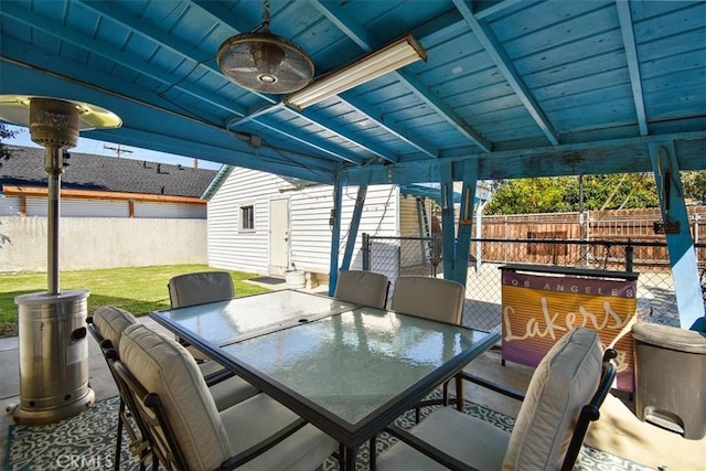 view of patio / terrace with outdoor dining area, an outdoor structure, and fence