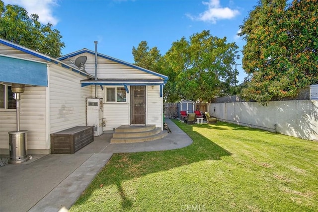 exterior space with fence, an outdoor structure, and a storage unit