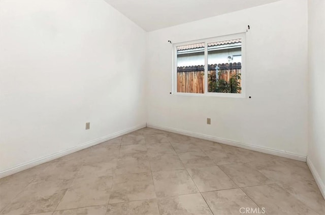 empty room featuring baseboards