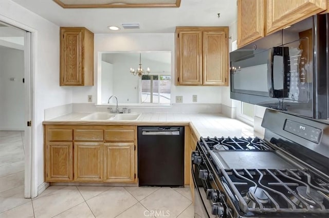 kitchen featuring visible vents, tile counters, a notable chandelier, black appliances, and a sink