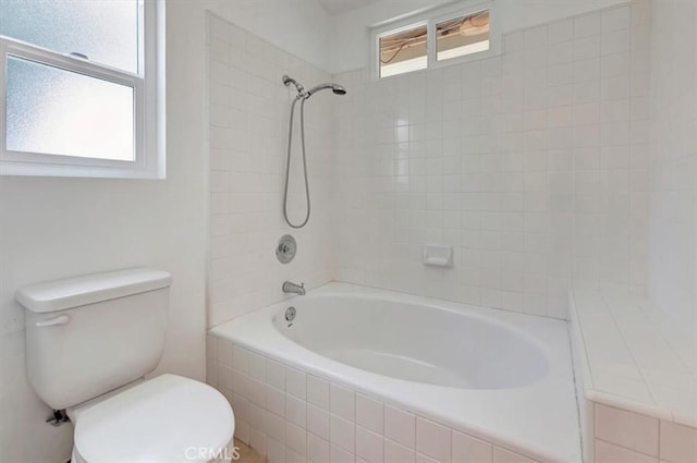 bathroom featuring toilet and  shower combination