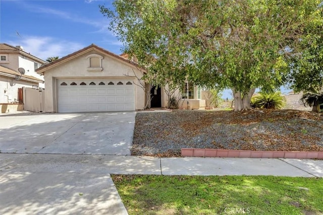 view of front of house featuring a garage, driveway, and stucco siding