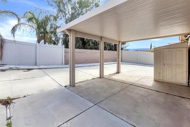 view of patio / terrace with a shed, an outdoor structure, and a fenced backyard