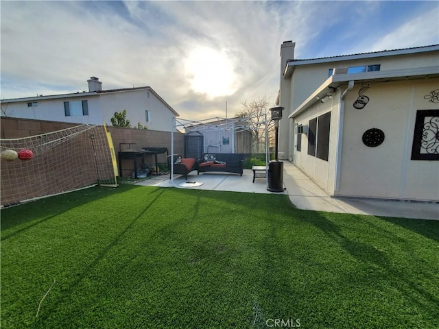 view of yard with a fenced backyard, a storage unit, an outbuilding, and a patio