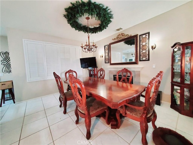 dining room with an inviting chandelier, light tile patterned floors, and visible vents