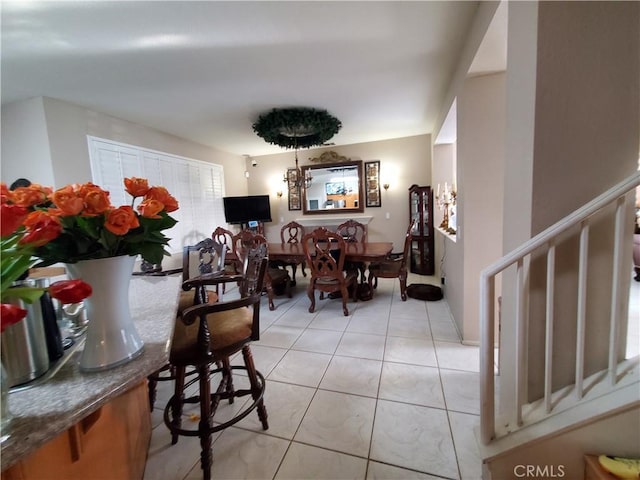 dining room with stairway and light tile patterned flooring