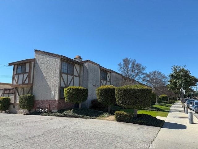 view of side of property with brick siding and stucco siding