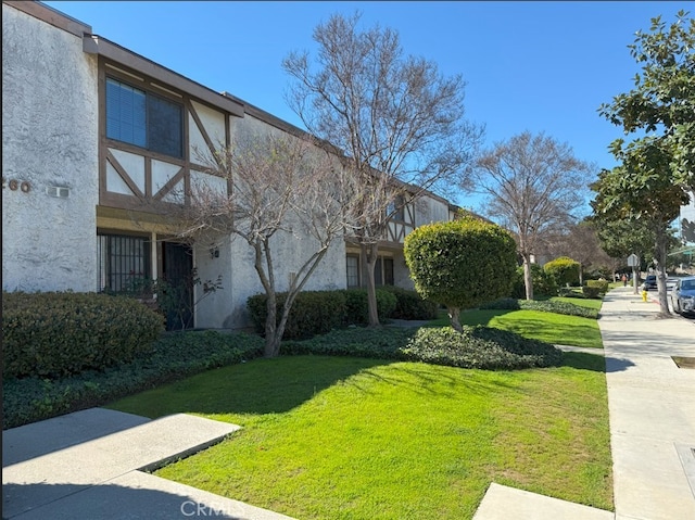 view of property exterior featuring a yard and stucco siding