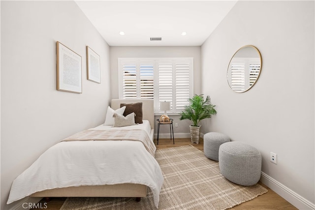 bedroom featuring recessed lighting, wood finished floors, visible vents, and baseboards