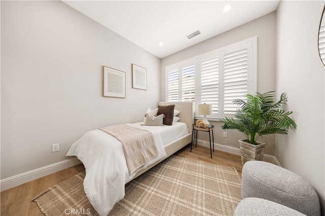 bedroom featuring recessed lighting, wood finished floors, visible vents, and baseboards