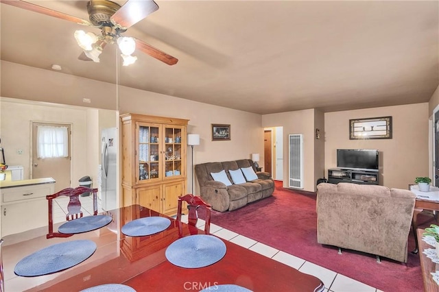 tiled dining space with carpet flooring and ceiling fan