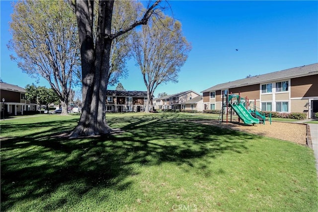 surrounding community with a residential view, playground community, and a yard