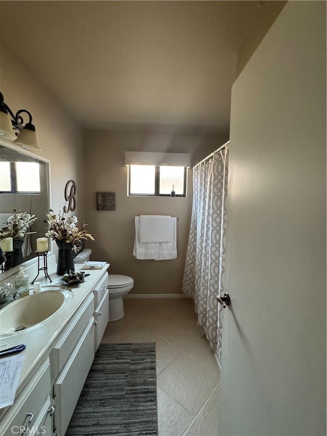 full bathroom with a wealth of natural light, vanity, toilet, and tile patterned floors