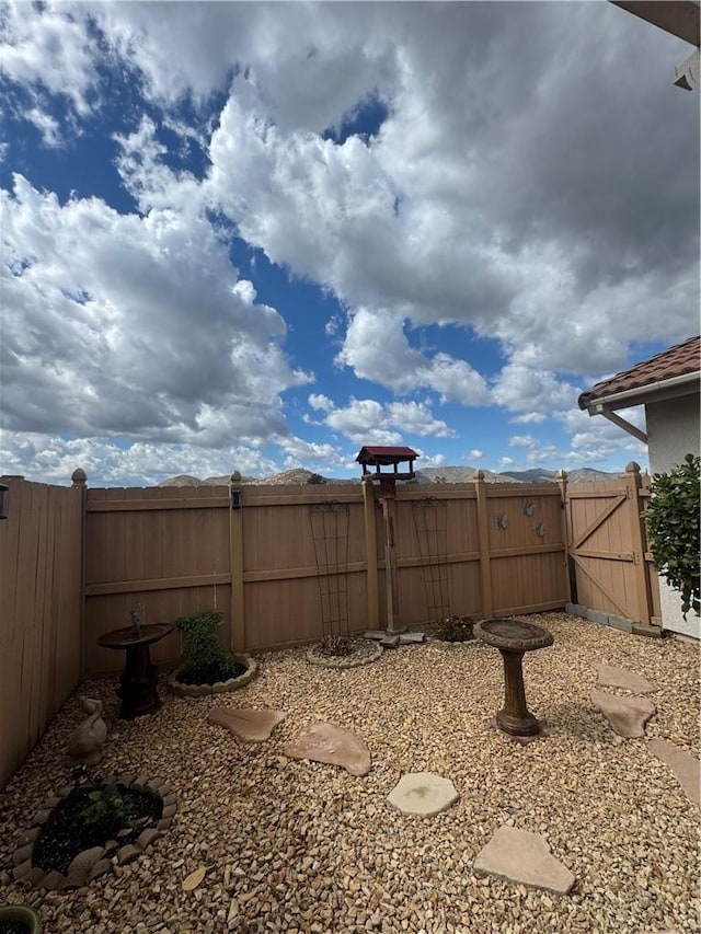 view of yard featuring fence and a gate