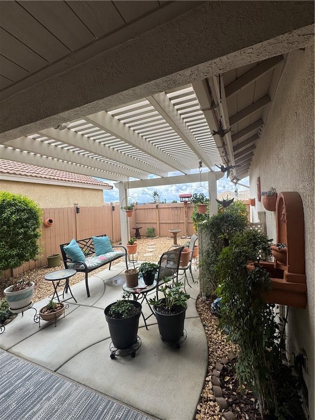 view of patio with outdoor lounge area, a fenced backyard, and a pergola