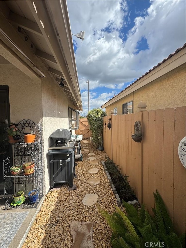 view of home's exterior featuring fence and stucco siding