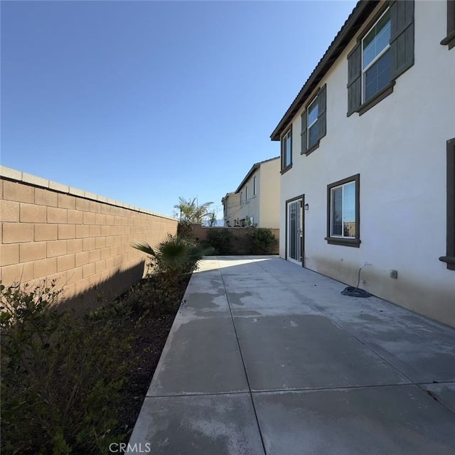 view of home's exterior featuring a patio area, a fenced backyard, and stucco siding