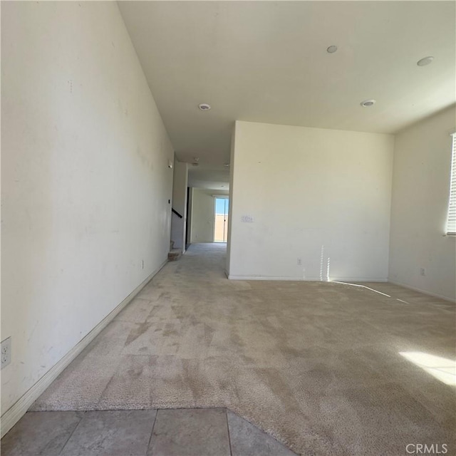 unfurnished room with light colored carpet