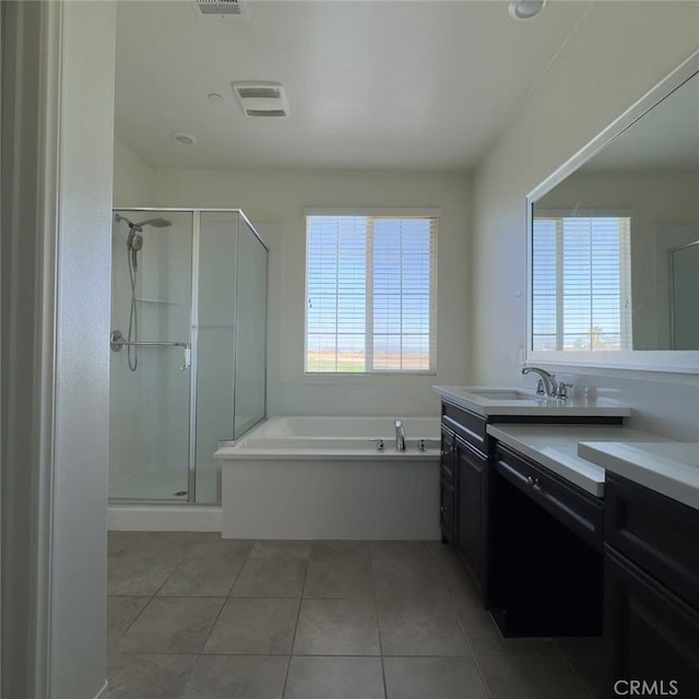 bathroom featuring tile patterned floors, visible vents, vanity, a shower stall, and a bath