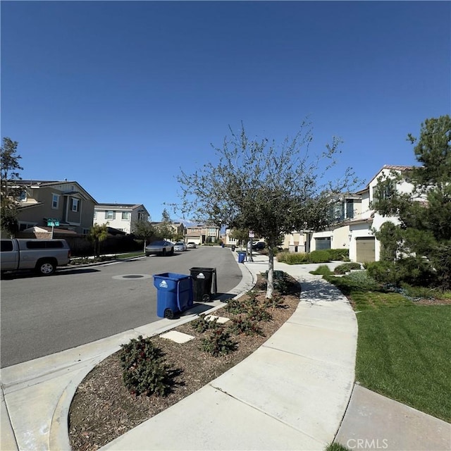 view of street with sidewalks and a residential view