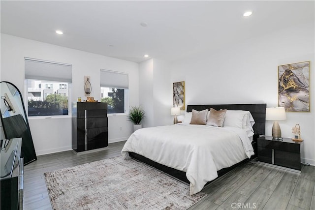 bedroom featuring recessed lighting, baseboards, and wood finished floors